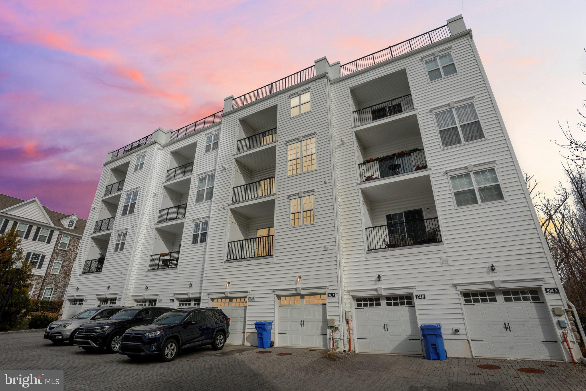 106 A Jay Alley Springfield, PA 19064 - Photo 40 of 44 Modern townhomes under a vibrant sunset.