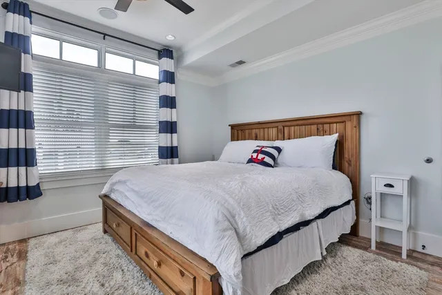 a bedroom with a large bed and a large window