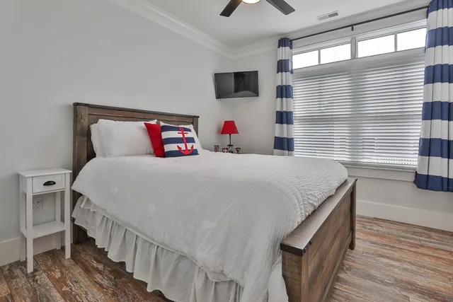 a bedroom with a bed and a large window