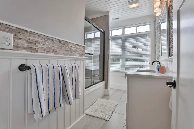 a bathroom with a shower and a sink