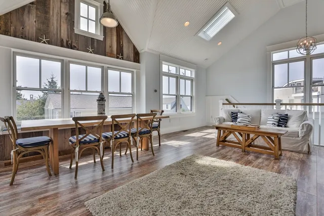 a view of a dining room with furniture window and wooden floor