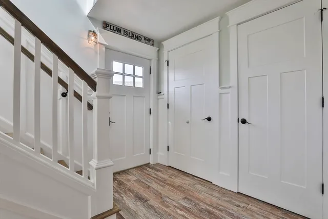 a view of a hallway with wooden floor and entryway