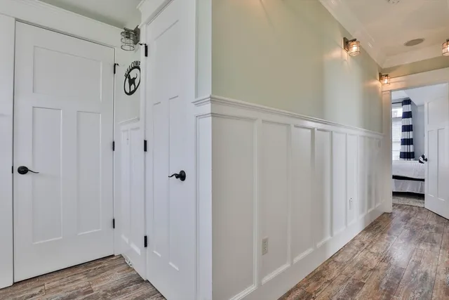 a view of a hallway with wooden floor and entryway