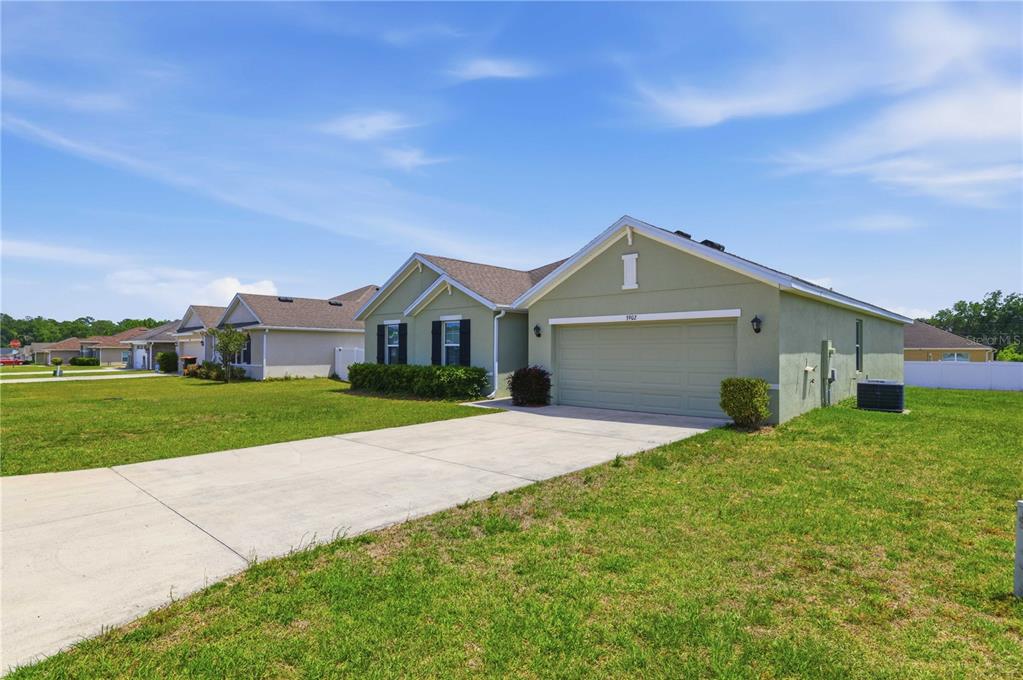 a front view of house with yard and green space