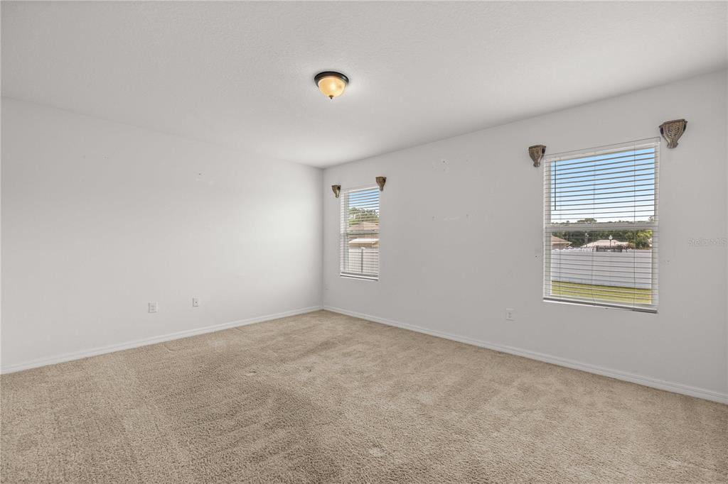 3902 Southeast 99th Street Belleview, FL 34420 - Photo 14 of 28 an empty room with windows