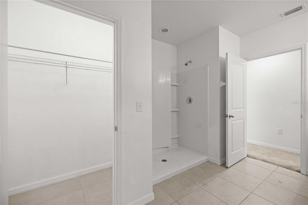 3902 Southeast 99th Street Belleview, FL 34420 - Photo 17 of 28 a bathroom with a shower and a glass door