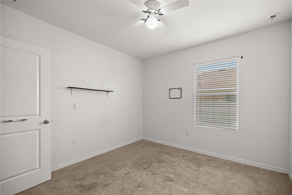 3902 Southeast 99th Street Belleview, FL 34420 - Photo 19 of 28 wooden floor in an empty room with a window