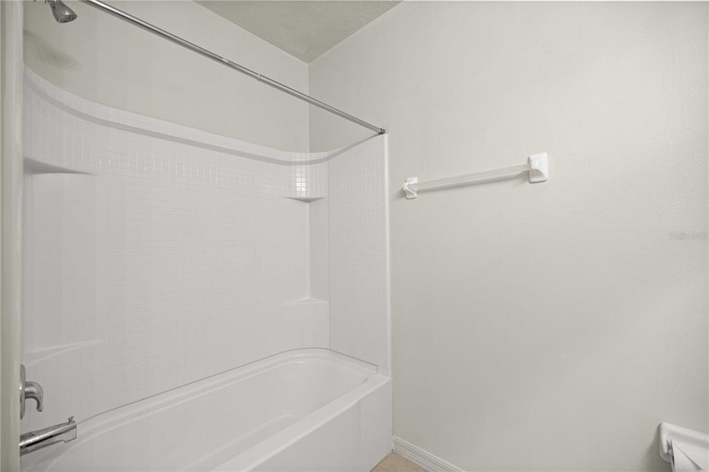 3902 Southeast 99th Street Belleview, FL 34420 - Photo 23 of 28 a bathroom with a bathtub
