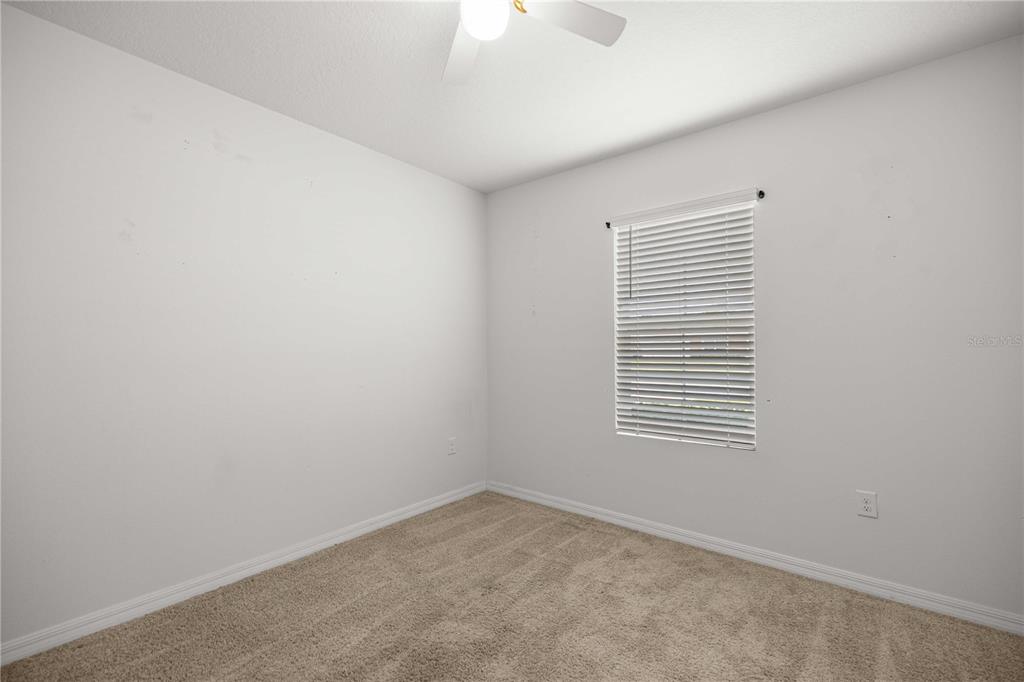 3902 Southeast 99th Street Belleview, FL 34420 - Photo 24 of 28 a view of an empty room with a window