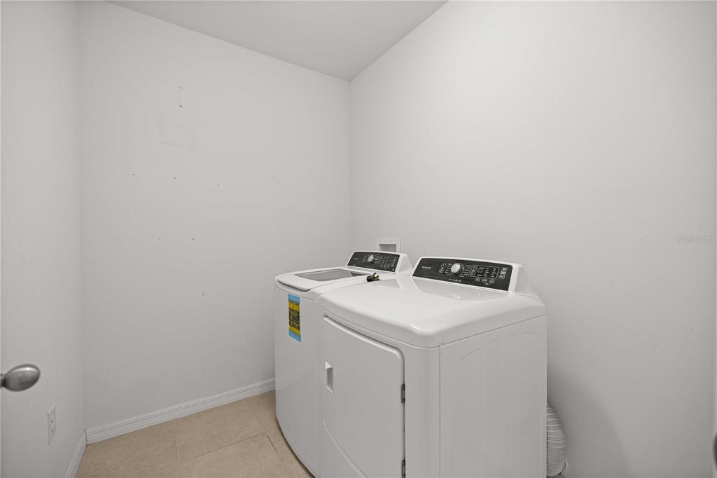 3902 Southeast 99th Street Belleview, FL 34420 - Photo 26 of 28 a utility room with dryer and washer