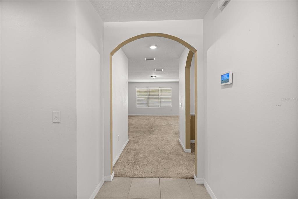 3902 Southeast 99th Street Belleview, FL 34420 - Photo 7 of 28 an entryway of a house with hallway