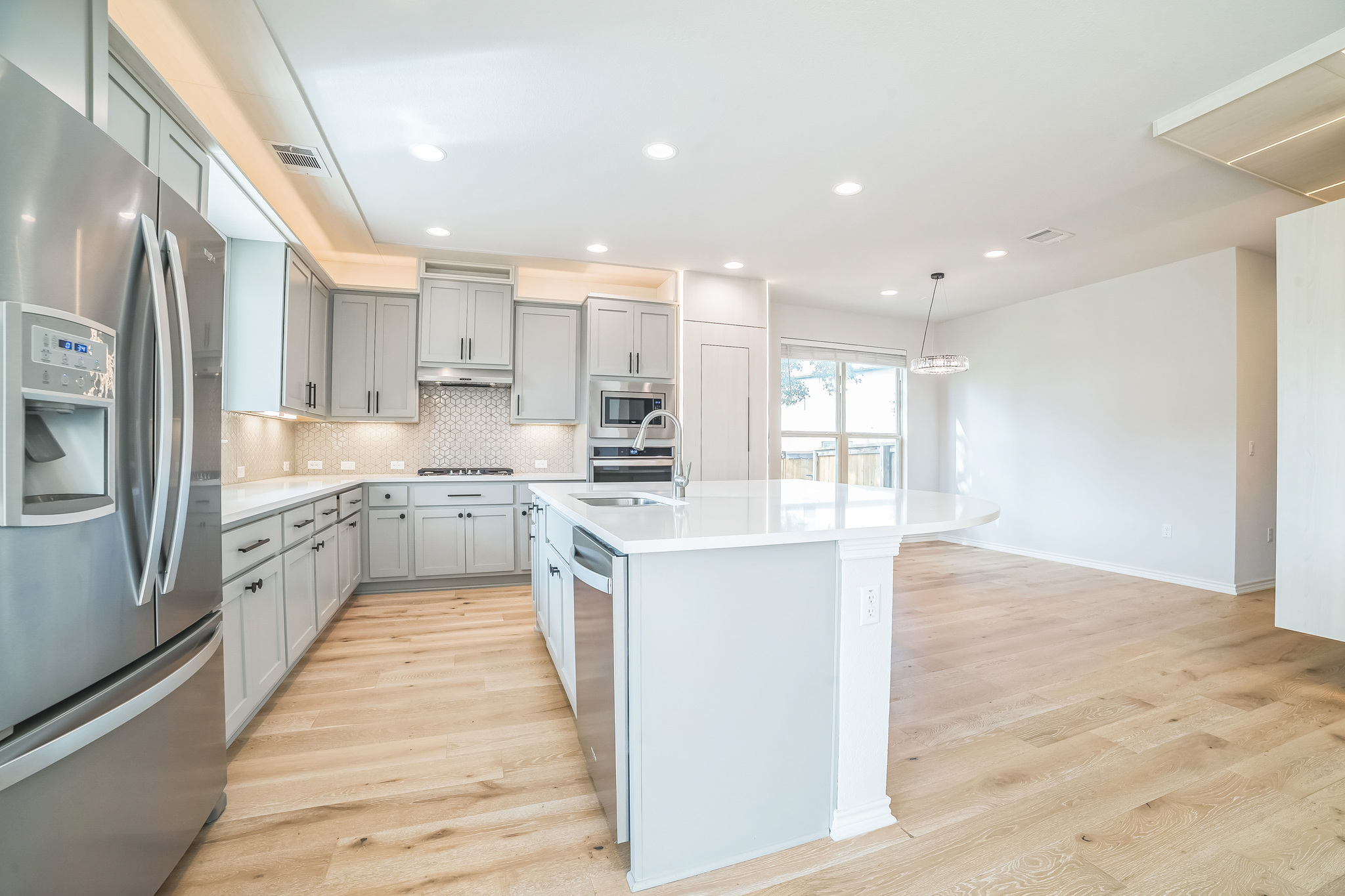 14300 McCoy Loop, Unit 21 Austin, TX 78717 - Photo 13 of 40 The kitchen features light-colored cabinetry, stainless steel appliances, and a central island with a white countertop