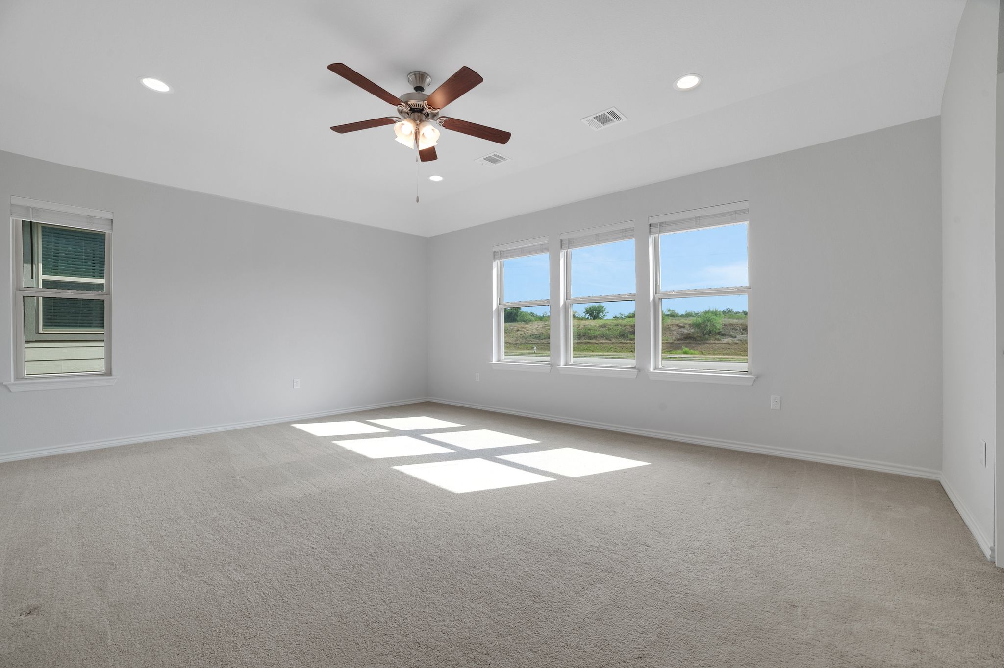 14300 McCoy Loop, Unit 21 Austin, TX 78717 - Photo 16 of 40 Spacious room featuring light-colored carpeting, recessed lighting, and a ceiling fan with integrated lighting