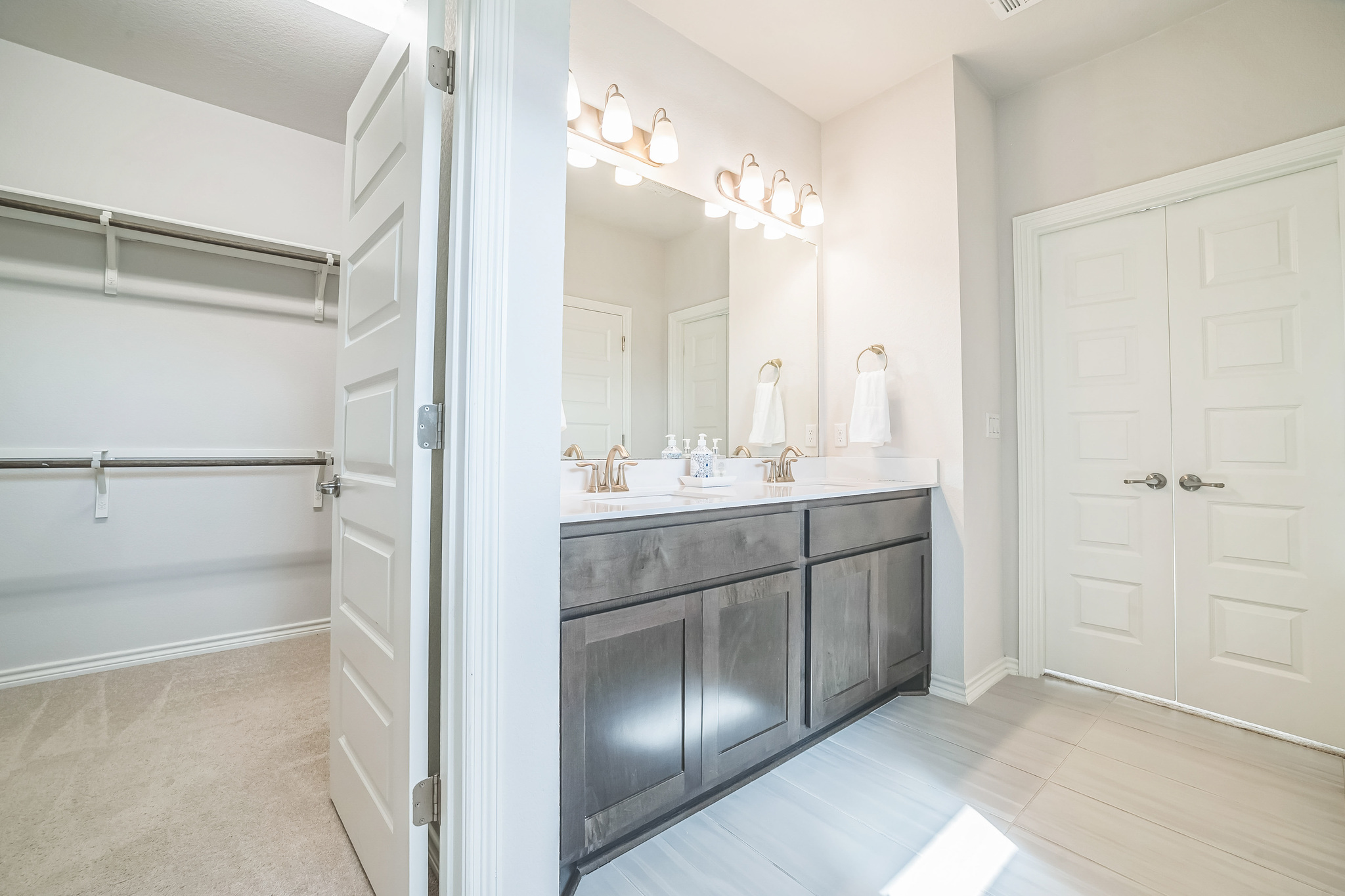 14300 McCoy Loop, Unit 21 Austin, TX 78717 - Photo 19 of 40 Bathroom featuring a dual vanity with a light-colored countertop and a mirror above