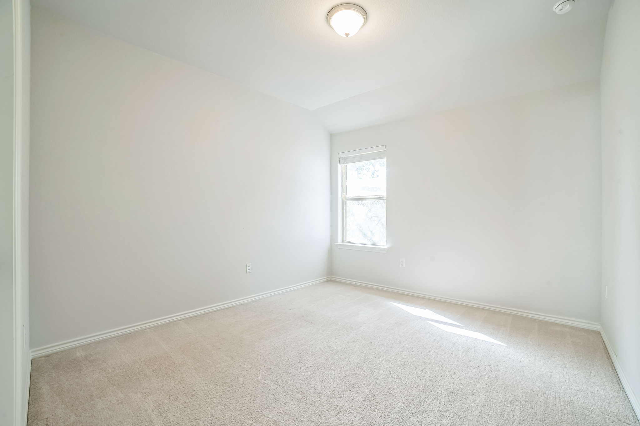14300 McCoy Loop, Unit 21 Austin, TX 78717 - Photo 22 of 40 This room features light-colored walls and carpeting, a window, and a ceiling light fixture