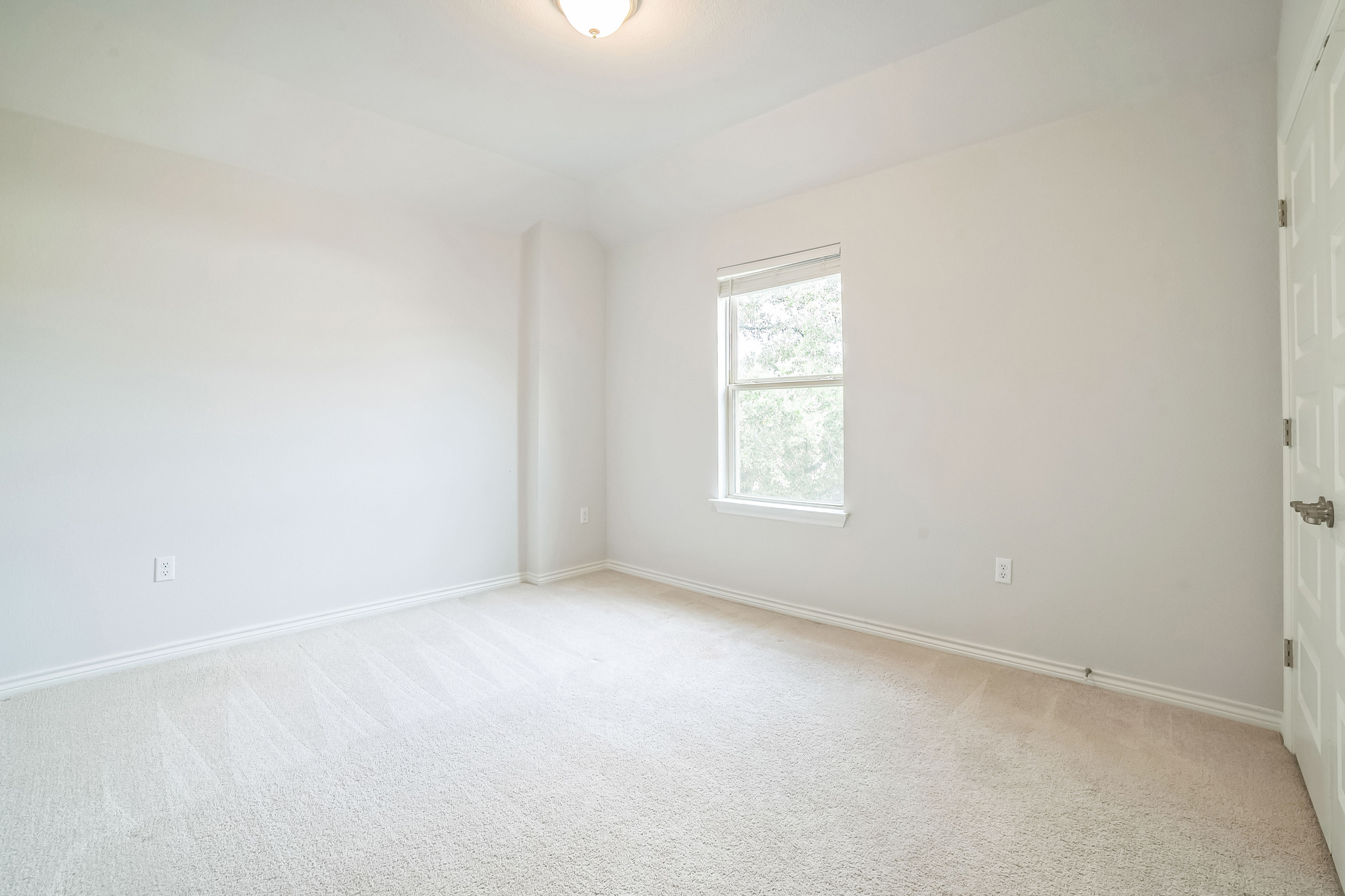 14300 McCoy Loop, Unit 21 Austin, TX 78717 - Photo 23 of 40 This room features light-colored carpeting, white walls, and a window providing natural light