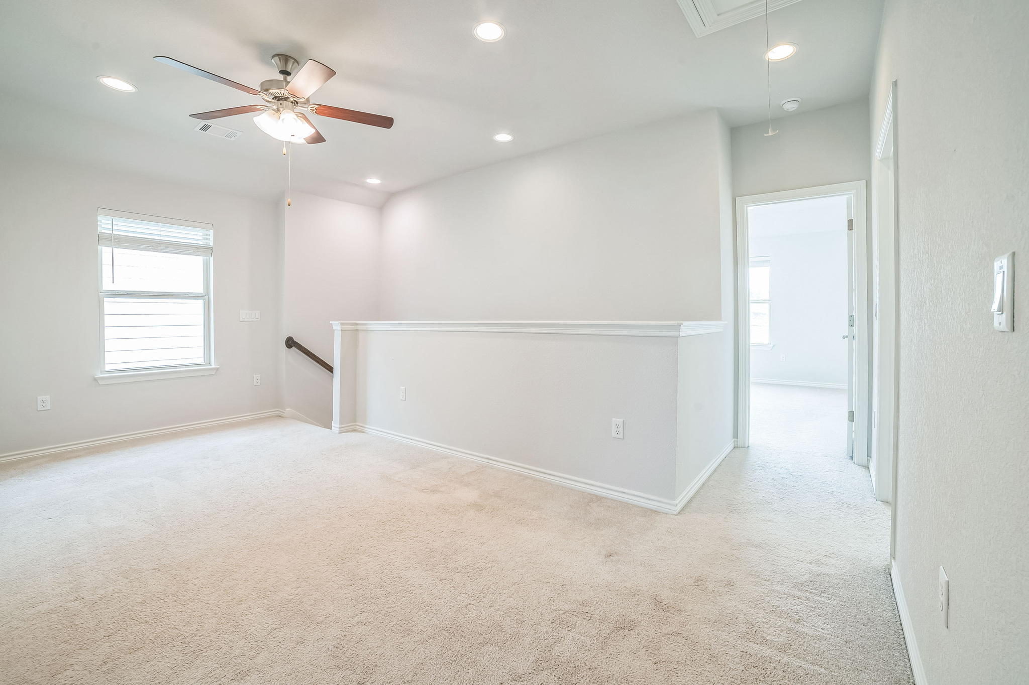 14300 McCoy Loop, Unit 21 Austin, TX 78717 - Photo 24 of 40 This spacious area features light-colored carpeting, a window with horizontal blinds, and a ceiling fan