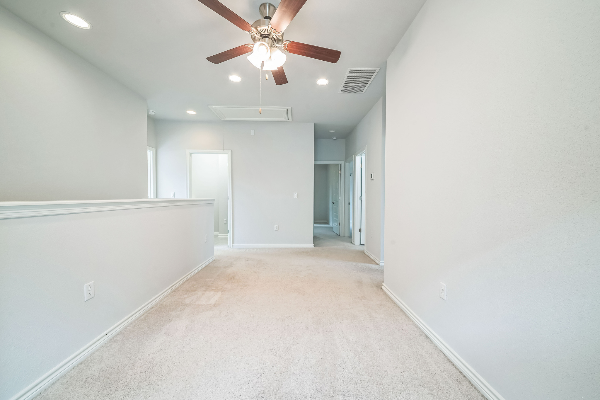 14300 McCoy Loop, Unit 21 Austin, TX 78717 - Photo 25 of 40 Expansive room featuring light-colored carpet, recessed lighting, and a ceiling fan with integrated lighting