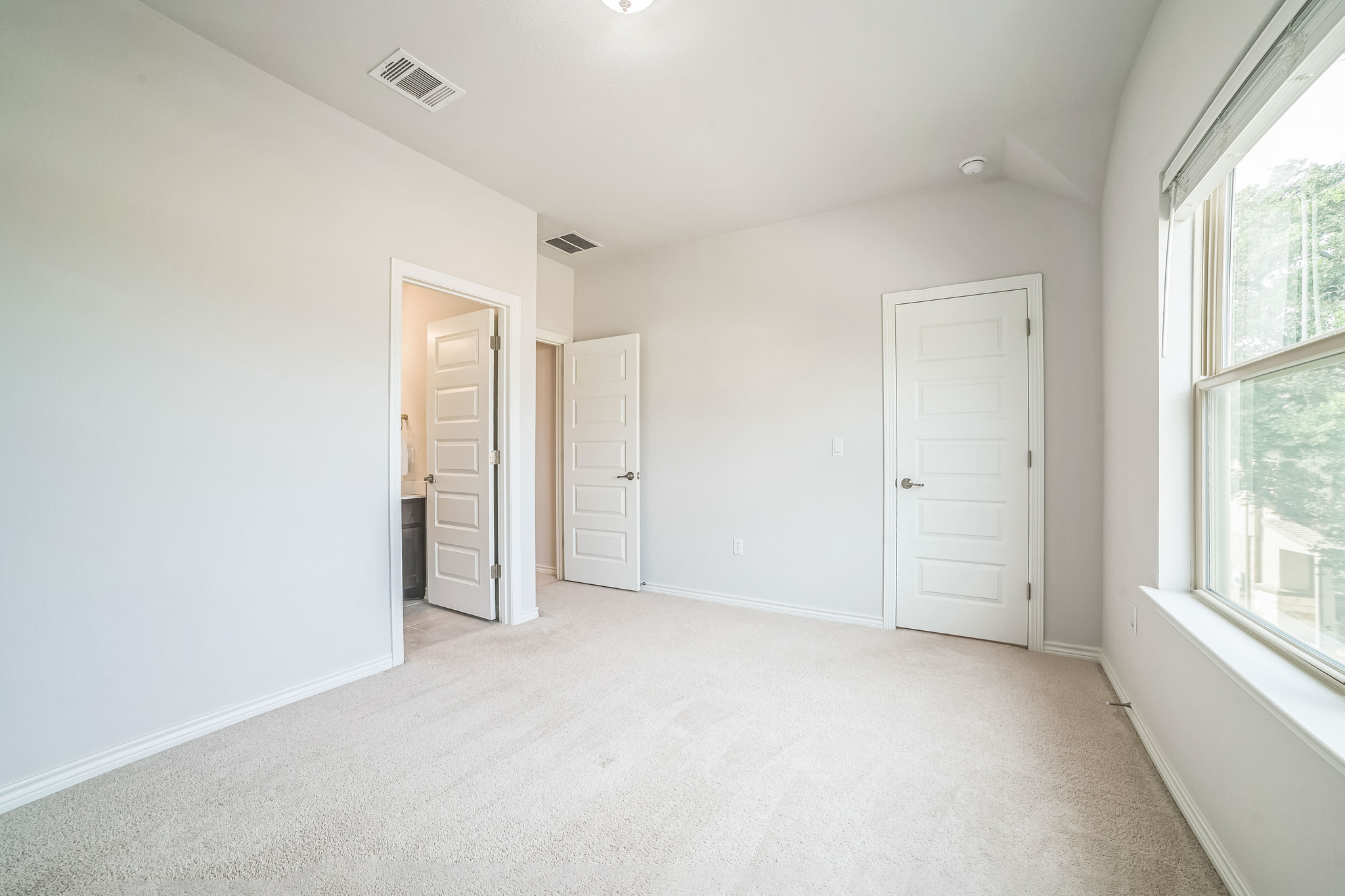 14300 McCoy Loop, Unit 21 Austin, TX 78717 - Photo 29 of 40 The room features light-colored carpeting, white walls, and white trim