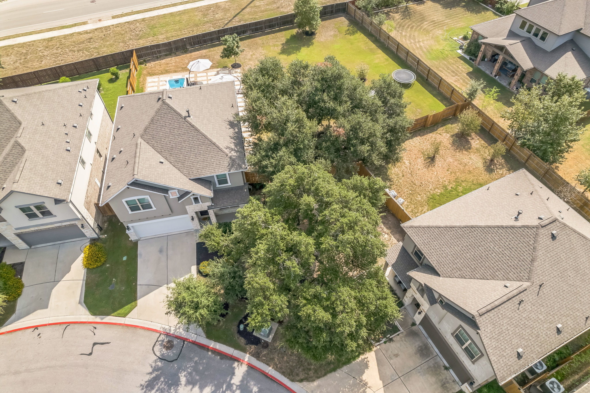 14300 McCoy Loop, Unit 21 Austin, TX 78717 - Photo 37 of 40 This property features a well-maintained exterior with a driveway leading to a garage