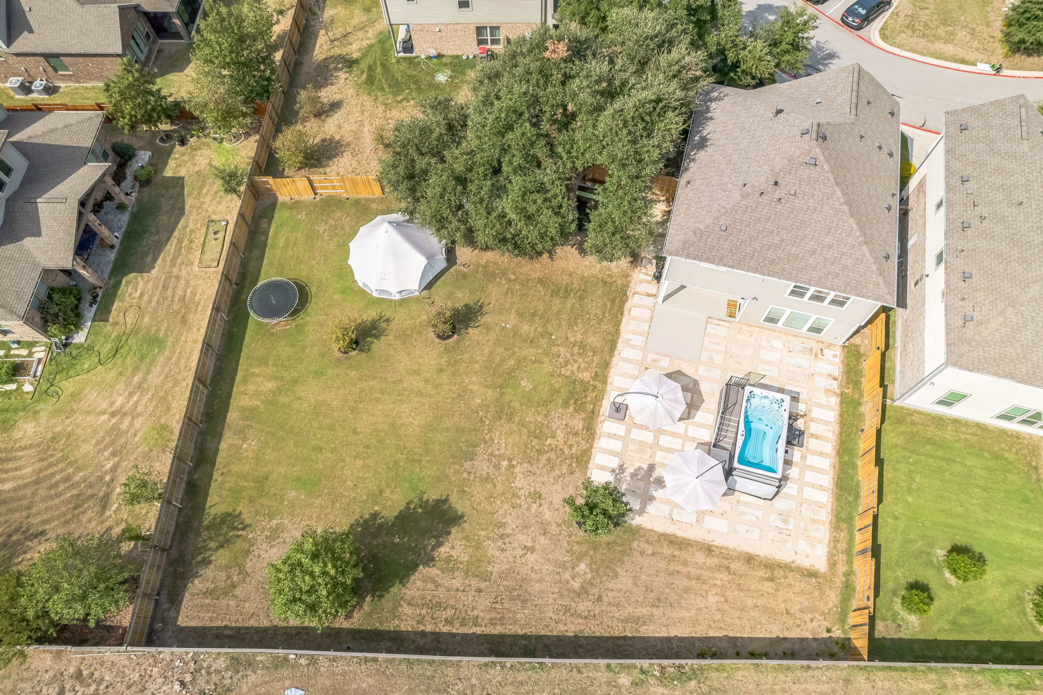 14300 McCoy Loop, Unit 21 Austin, TX 78717 - Photo 39 of 40 The property features a private backyard with a swimming pool, a patio area, and a large lawn