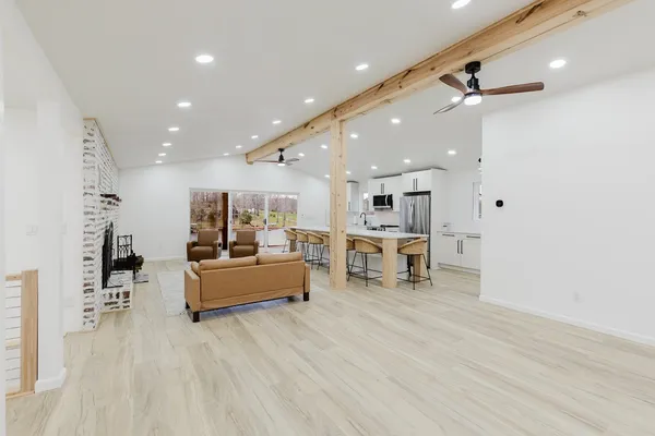 a large kitchen with stainless steel appliances a large counter top space