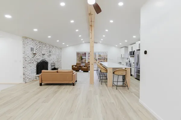 a view of kitchen with furniture and refrigerator