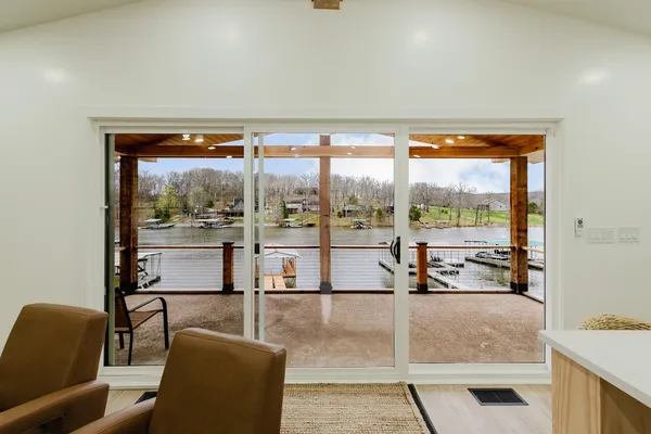 a large kitchen with lots of counter space a sink and chairs