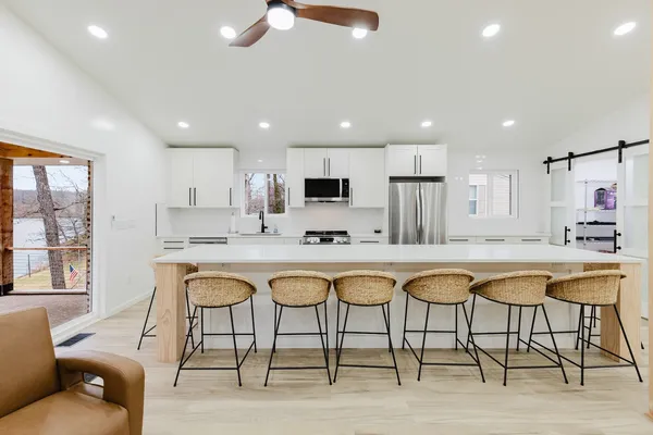 a kitchen with kitchen island a sink stainless steel appliances and cabinets