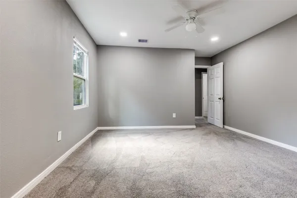 an empty room with windows and closet