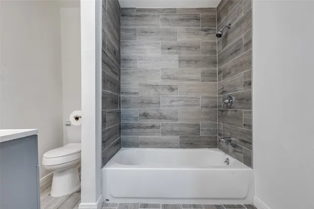 a bathroom with a shower and a toilet