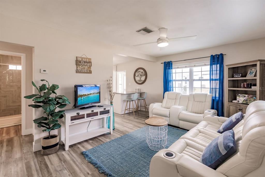 688 Constance Road Venice, FL 34293 - Photo 2 of 11 a living room with furniture and a flat screen tv