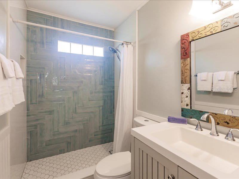 688 Constance Road Venice, FL 34293 - Photo 7 of 11 a bathroom with a sink toilet and shower