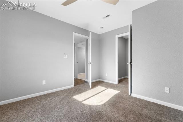 4540 Sierra Rica Road Colorado Springs, CO 80911 - Photo 37 of 42 Unfurnished bedroom featuring carpet floors, a textured wall, and ceiling fan