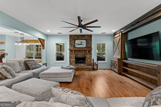 a living room with furniture a flat screen tv and a fireplace