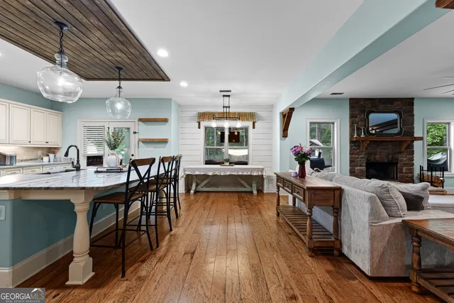 a view of a dining room with furniture and wooden floor