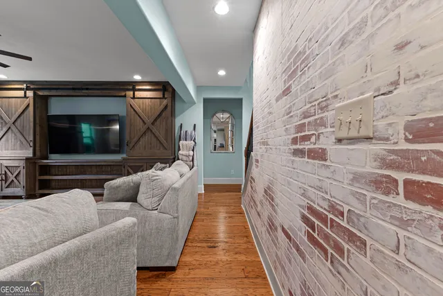 a bedroom with a bed and a flat tv screen on dresser