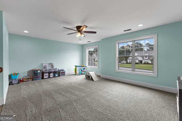 a bedroom with a bed and a ceiling fan