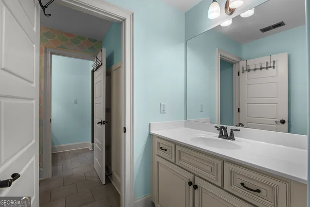 a view of a hallway and a livingroom with furniture