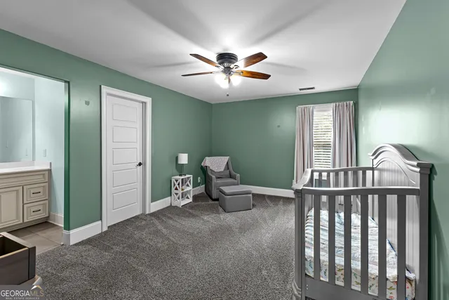 a view of an empty room with a chandelier fan