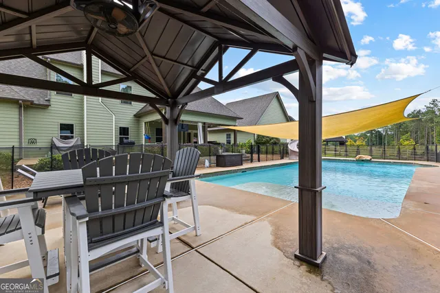 a view of a room with a ceiling fan and wooden floor