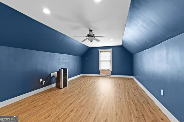 a front view of a house with a garden and yard