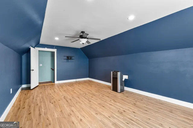 a white house with a big yard and large trees