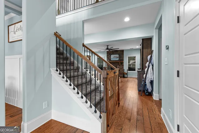 a view of entryway and hall with wooden floor