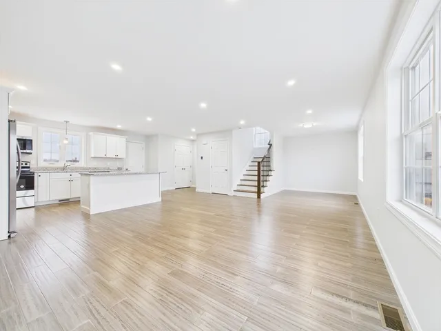 a view of kitchen with wooden floor and windows