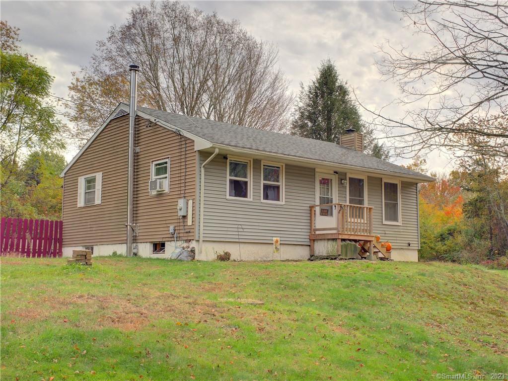 a front view of house with yard and green space