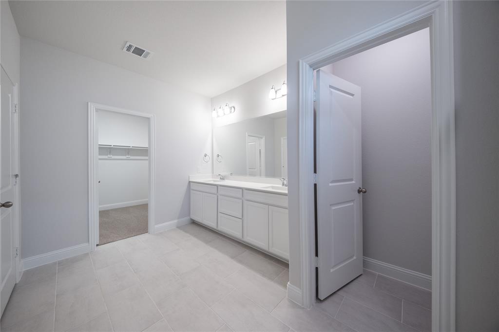 7913 Sunset Boulevard Rowlett, TX 75088 - Photo 9 of 25 a bathroom with a double vanity sink mirror and shower