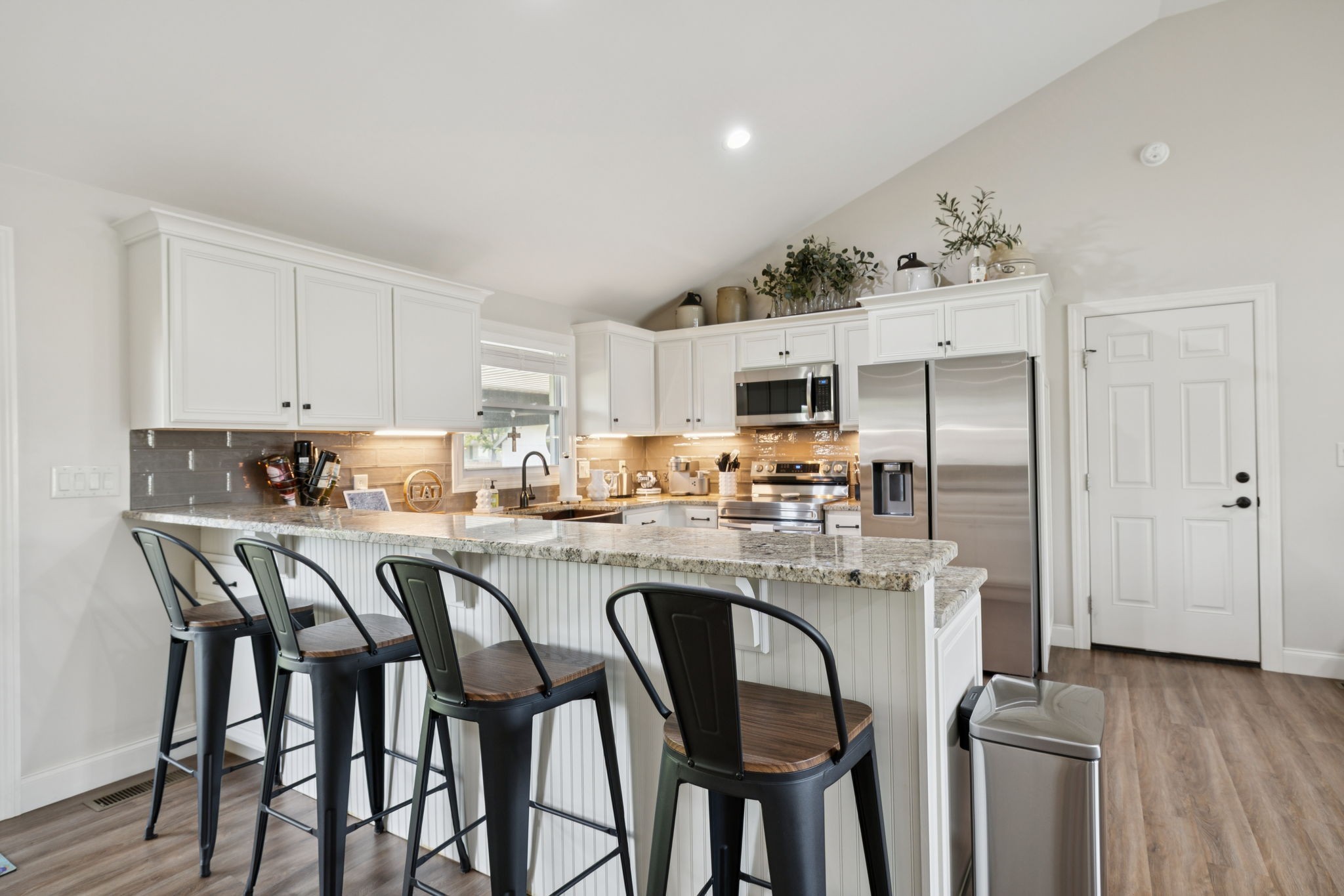 213 Knob Road Lebanon, TN 37087 - Photo 15 of 39 a kitchen with granite countertop a table chairs microwave and cabinets