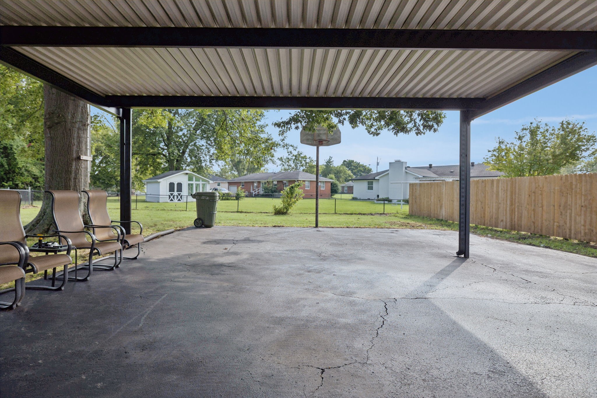 213 Knob Road Lebanon, TN 37087 - Photo 35 of 39 a view of a patio with table and chairs under an umbrella with a small yard