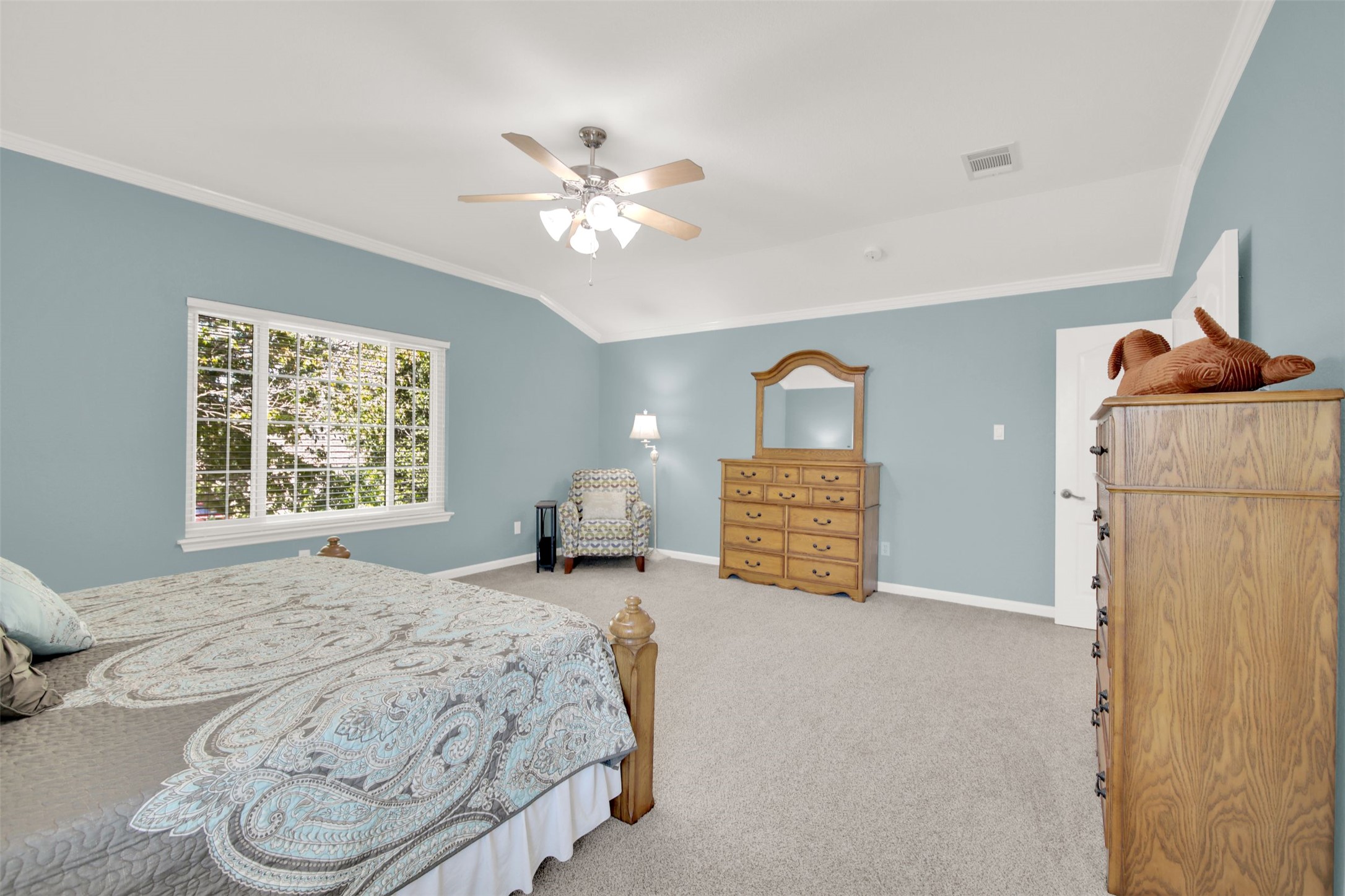 1210 Mathias Street Cedar Park, TX 78613 - Photo 22 of 31 Bedroom with crown molding, vaulted ceiling, a ceiling fan, and light carpet